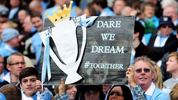 Manchester City fans cheer their team on during the match against Queens Park Rangers.