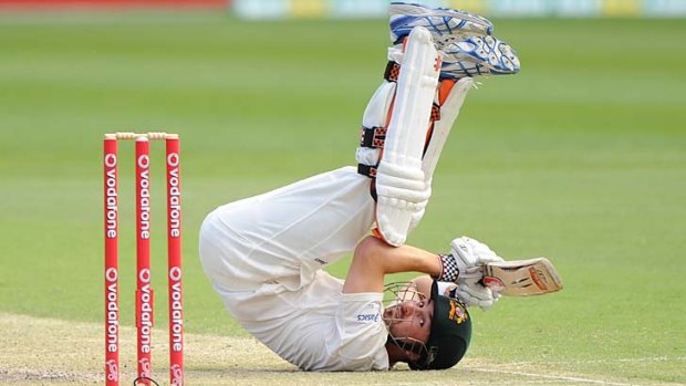 Evasive action.... Ed Cowan of Australia falls onto his back during day four at the Gabba.