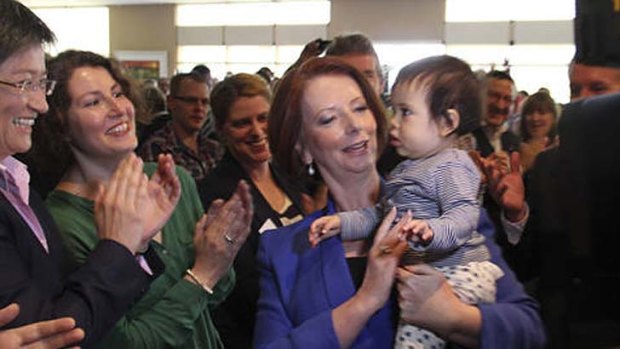 Baby love &#8230; Julia Gillard posted this photo on Twitter yesterday of her holding Penny Wong and Sophie Allouache's daughter, Alexandra, at the SA Labor conference.