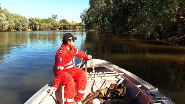 Hopeless: Rangers search for the body of Sean Cole who was taken by a crocodile on Mary River.