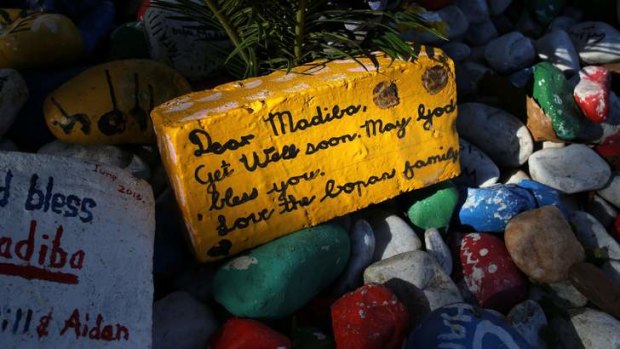Warm wishes: A get-well message is seen on a brick outside Nelson Mandela's garden in Houghton, Johannesburg on Saturday.