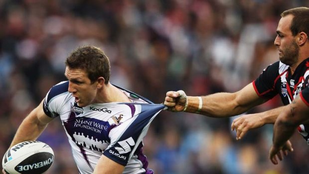 Ripper: Warrior Simon Mannering clings onto Melbourne Storm's Ryan Hoffman in Auckland yesterday.