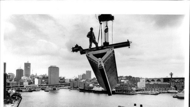 A roof section is lifted over Circular Quay during the  Sydney Opera House construction in 1967.