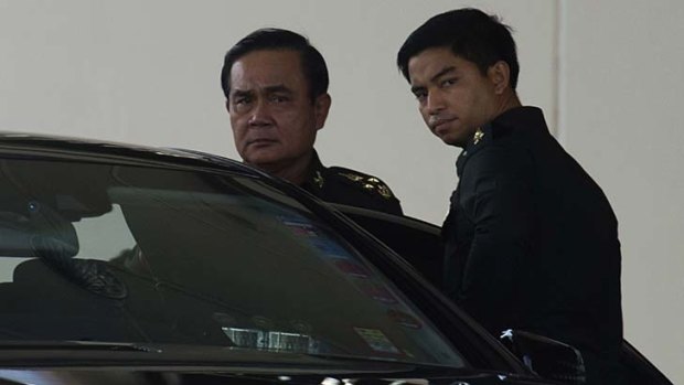 Thailand's army chief General Prayuth Chan-ocha (left) leaves after meeting with anti-government and pro-government leaders.