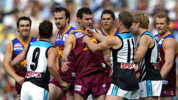 Mild-mannered Lion midfielder Simon Black, back, centre, will be the only one of the aggressors booked after the 2004 grand final.