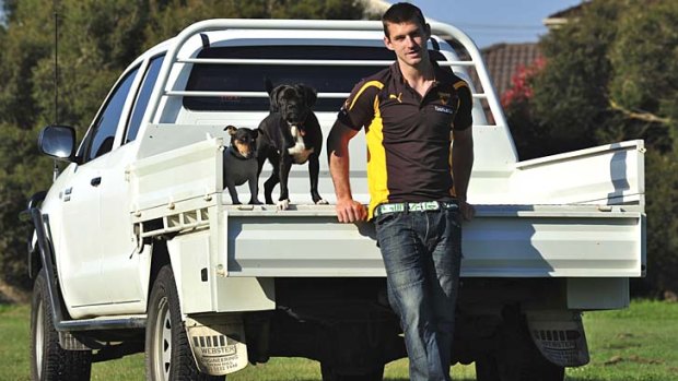Utility player: Brendan Whitecross with his dogs Cobe and Cobber.