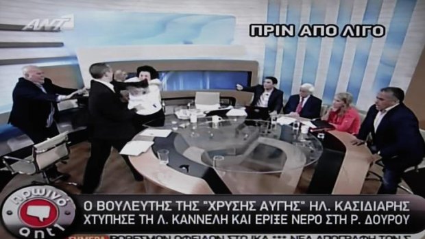 A screenshot shows Golden Dawn spokesman Ilias Kasidiaris, 2nd left,  strike Liana Kanelli, a female member of the Greek Communist party, during a talk show.