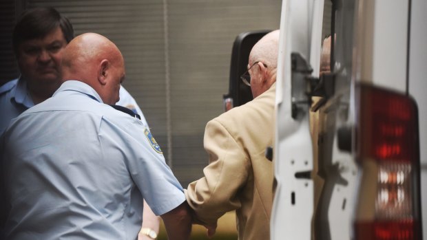 Roger Rogerson being led into the Supreme Court in Sydney on Monday.