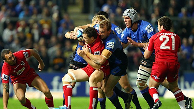 Patrick Dellit of the Force tackles Luke Morahan of the Reds.