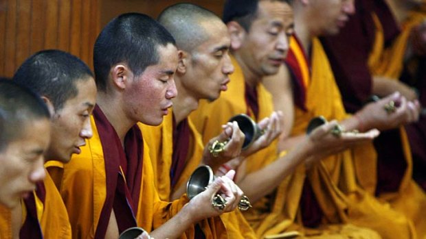 Tibetan monks: Allowed to venerate the Dalai Lama as a spiritual leader.