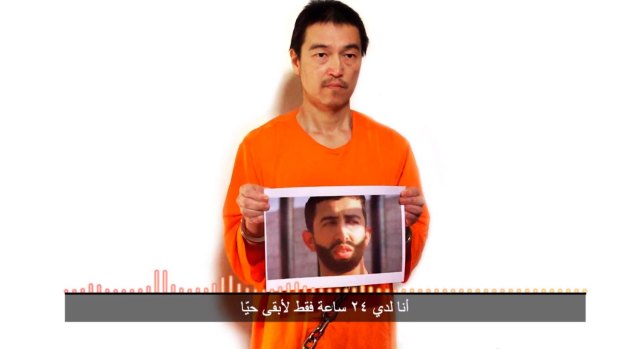 Islamic State hostages: Japanese journalist Kenji Goto holds what appears to be a photo of Jordanian pilot 1st Lieutant Mu'ath al-Kaseasbeh in a still photo from video posted on YouTube on Tuesday. The Arab subtitle reads, "I only have 24 hours left to live".