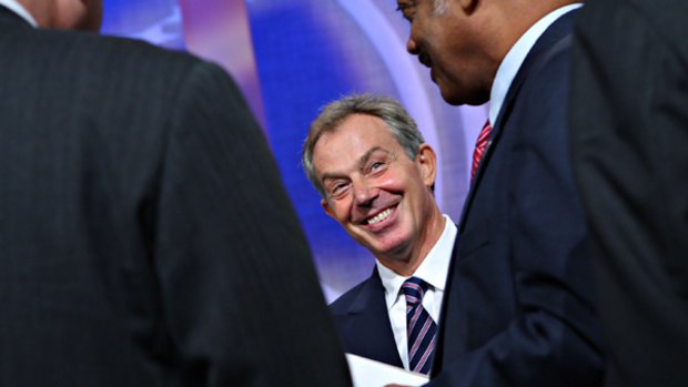 Tony Blair talks with the Reverend Jesse Jackson in New York.