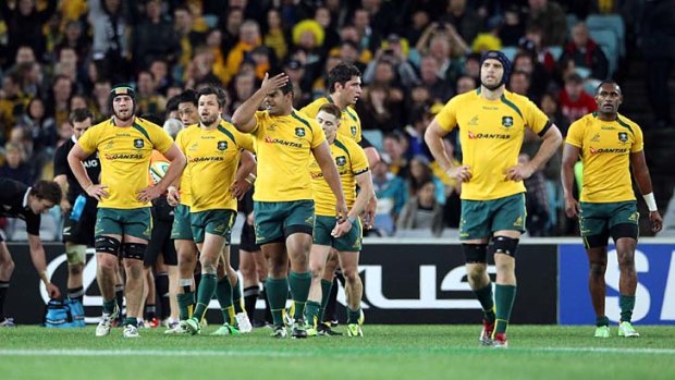 Dejected: The Wallabies after their defeat against the All Blacks on Saturday night.