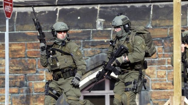 Members of a Mounted Police intervention team on alert at the  Parliament building.