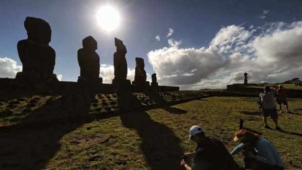 Tourists visit Moais, the stone statues of the Rapa Nui culture, on Easter Island as they wait for the total solar eclipse.