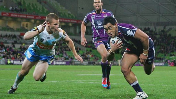 Mahe Fonua (right) of the Storm in action against the Gold Coast Titans last season.