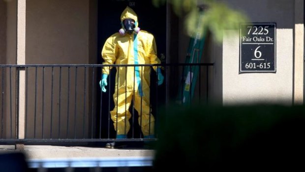 SERIOUS PROTECTION: A hazmat team member arrives to clean a unit at the Ivy Apartments in Dallas, Texas, where the first confirmed Ebola virus patient in the US was staying.