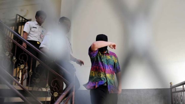 The 14-year-old New South Wales youth is escorted from a detention house in Denpasar to the first day of his drug trial.