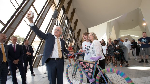 Prime Minister Malcolm Turnbull takes a selfie with the bike, its artist Eloise Murphy and his wife Lucy at the National Museum of Australia on Thursday.