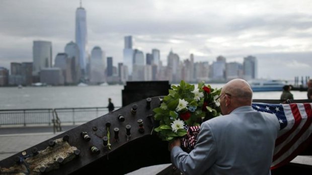 A man places a wreath at the 9/11 memorial during the 13th anniversary of the 9/11 attacks on the World Trade Centre, in Exchange Place, New Jersey.