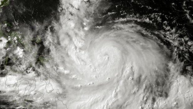 A satellite image of Typhoon Rammasun taken on Tuesday. Tens of thousands of people in the Philippines sheltered in evacuation centres on Wednesday.