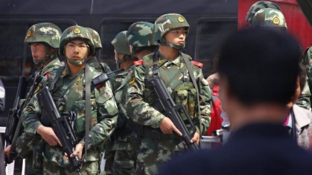 Paramilitary policemen stand guard near the exit of Urumqi's South Railway Station, scene of  a bomb and knife attack on Wednesday.