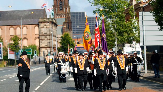 Orange order members march, in North Belfast, Northern Ireland.
