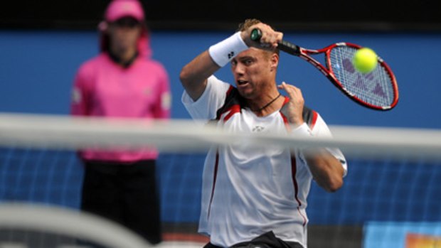 Lleyton Hewitt books his place in the third round with an easy victory against American Donald Young.