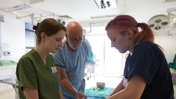 A touch of reality &#8230; veterinary students Meredith Wall, left, and Sophie Moffat with Professor Max Zuber.