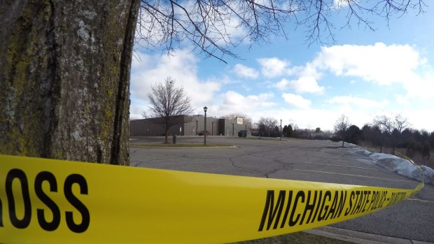 Police tape surrounds one of the crime scenes in Kalamazoo, Michigan on Sunday.