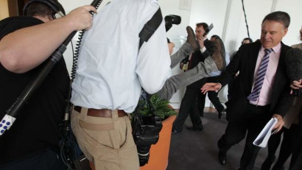 Labor MP Joel Fitzgibbon tries to avoid the flailing legs of a Channel 9 cameraman at Parliament House on Wednesday.