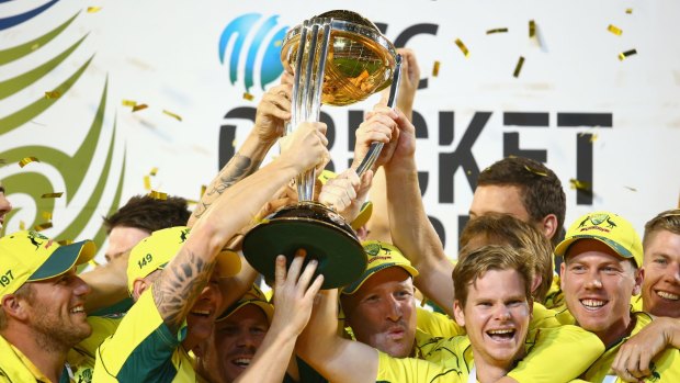 The Australian team cheer as they lift the World Cup trophy.