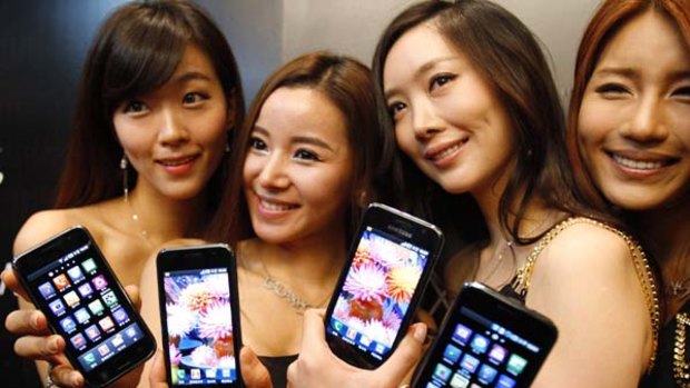 Models pose with the new Samsung Galaxy S Android smartphone during its launch ceremony at the headquarters of Samsung Electronics in Seoul.