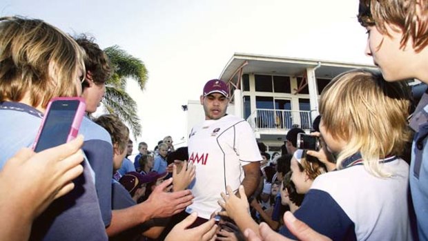 Centre stage ... young fans swamp Maroons superstar Greg Inglis at a training session on the Sunshine Coast during the week.