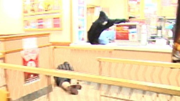 A still from a video released by the Omaha Police Department showing the armed robber shooting at police.