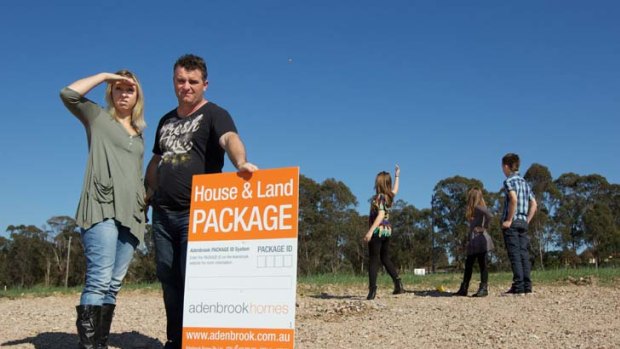 'It was the affordability that made us buy in Jordan Springs' ... Adam and Lisa Mercer with their children on their land at Jordan Springs, a new Sydney suburb.