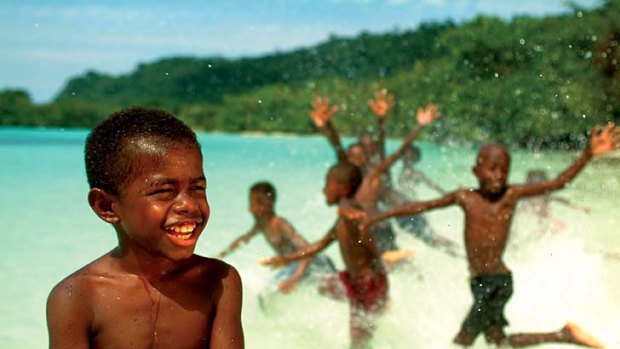 Wet and wild ... beach life for Vanuatuan children.