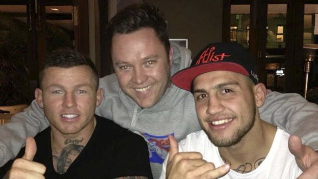 Cronulla Sharks star and former Raider Todd Carney, left, and current Raiders star Blake Ferguson, right, with a fan at Clovelly Hotel on Saturday night.