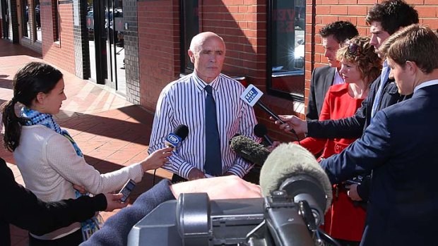 That's all: Paul Little makes his media statement outside Essendon's headquarters.