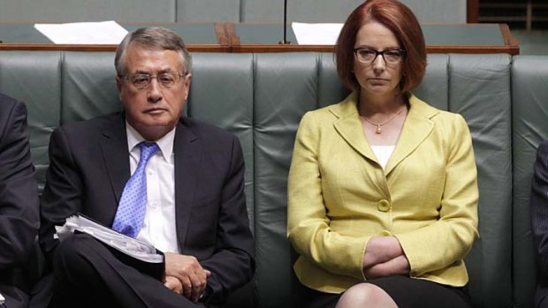 Storm coming: Treasurer Wayne Swan and Prime Minister Julia Gillard in Parliament on Monday.