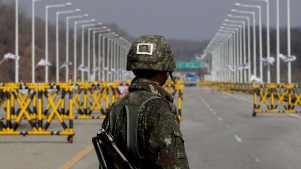 Opening the barriers: A South Korean soldier stands at a military checkpoint connecting South and North Korea at the Unification Bridge in Paju, South Korea.