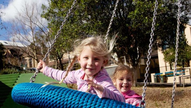 Close to home ... Lola Birley and Sophie Jollow, both 4, on the ''flying saucer'' at Constellation Playground.