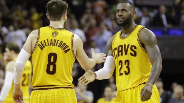 Cleveland Cavaliers forward LeBron James celebrates with teammate Matthew Dellavedova.