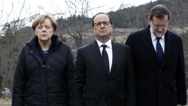 German Chancellor Angela Merkel, left, French President Francois Hollande, centre, and Spanish Prime Minister Mariano Rajoy pay their respects near the mountain where a Germanwings jetliner crashed.