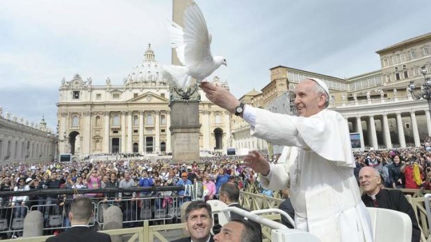 Gift of flight: Pope Francis frees a dove at the Vatican.
