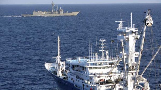 Freed . . . the Spanish tuna fishing boat Alakrana sails safely near a Spanish warship in the Indian Ocean.