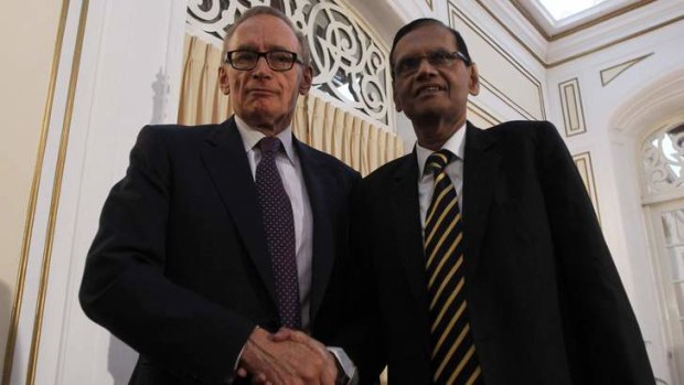Australian Foreign Minister Bob Carr shakes hands with his Sri Lankan counterpart Gamini Lakshman Peiris during a joint media conference in Colombo in December, 2012.