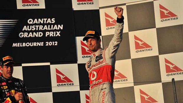 Spot on: Jenson Button acknowledges the cheers from the crowd on the winner's podium yesterday.