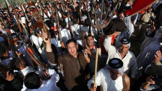 Iraqi Shiite tribesmen gather to show their readiness to fight against ISIL militants.