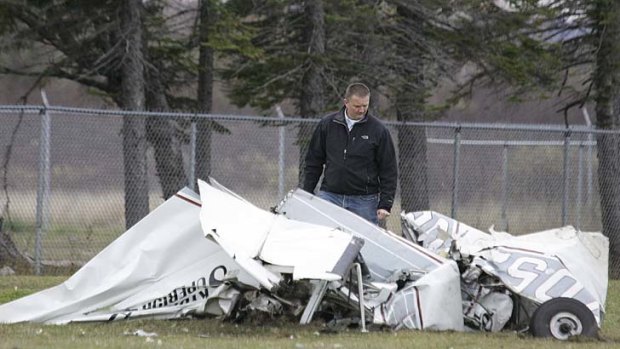 An FAA investigator examines the wreckage.